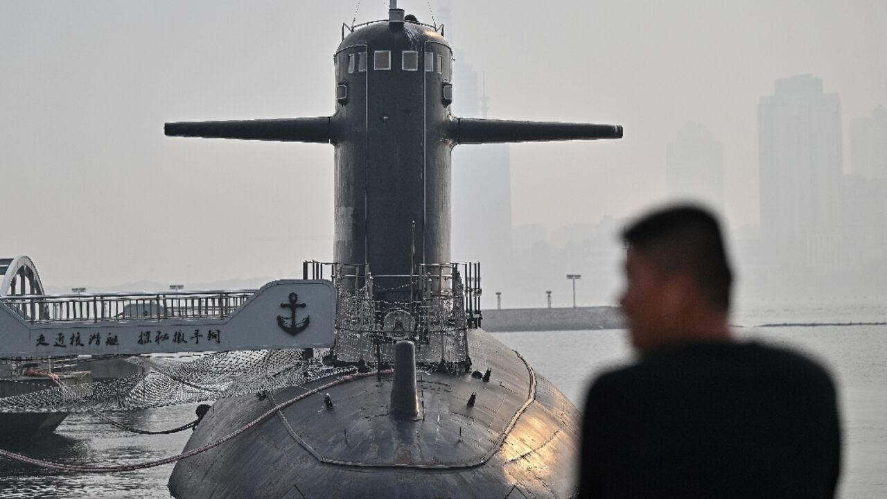 A man looks at a submarine during a media tour by the PLA Naval Museum, organized by the Chinese People's Liberation Army Navy A man looks at a submarine during a media tour by the PLA Naval Museum, organized by the Chinese People's Liberation Army Navy