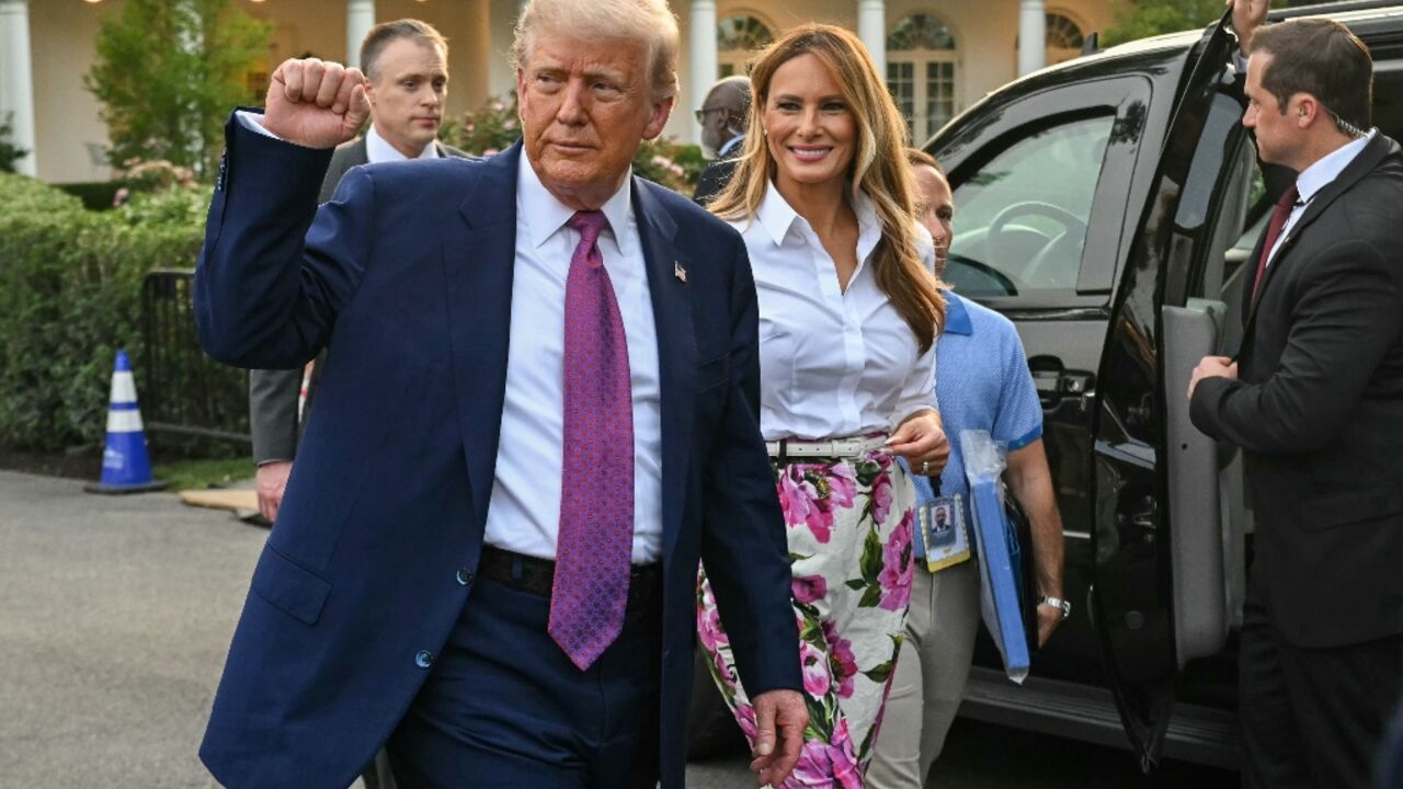 US President Donald Trump (L) raises a fist next to US First Lady Melania Trump during the Congressional Picnic on the South Lawn of the White House in Washington, DC, on June 12, 2025. US President Donald Trump (L) raises a fist next to US First Lady Melania Trump during the Congressional Picnic on the South Lawn of the White House in Washington, DC, on June 12, 2025.