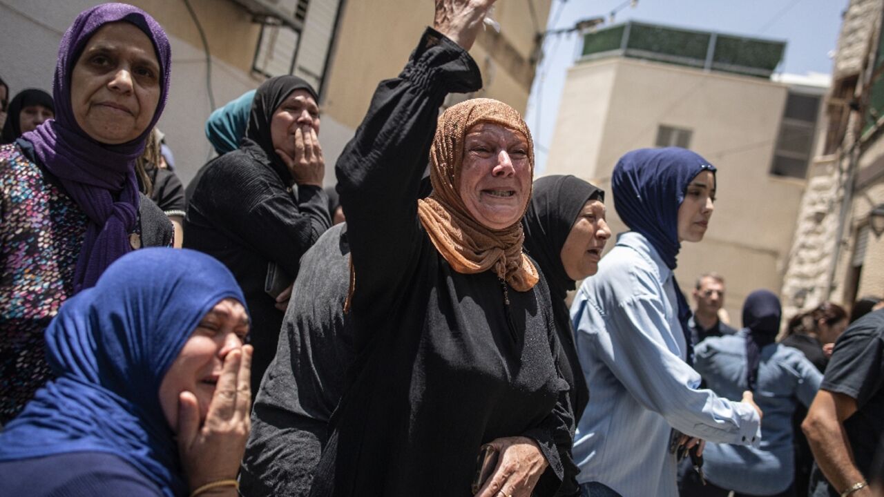 Mourners at a funeral for victims of an Iranian missile attack which destroyed a three-storey building in the northern city of Tamra Mourners at a funeral for victims of an Iranian missile attack which destroyed a three-storey building in the northern city of Tamra
