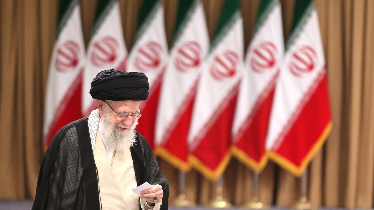 Iran's supreme leader Ayatollah Ali Khamenei prepares to cast his ballot during the runoff of the presidential elections in Tehran on July 5, 2024. (Photo by ATTA KENARE / AFP) (Photo by ATTA KENARE/AFP via Getty Images)