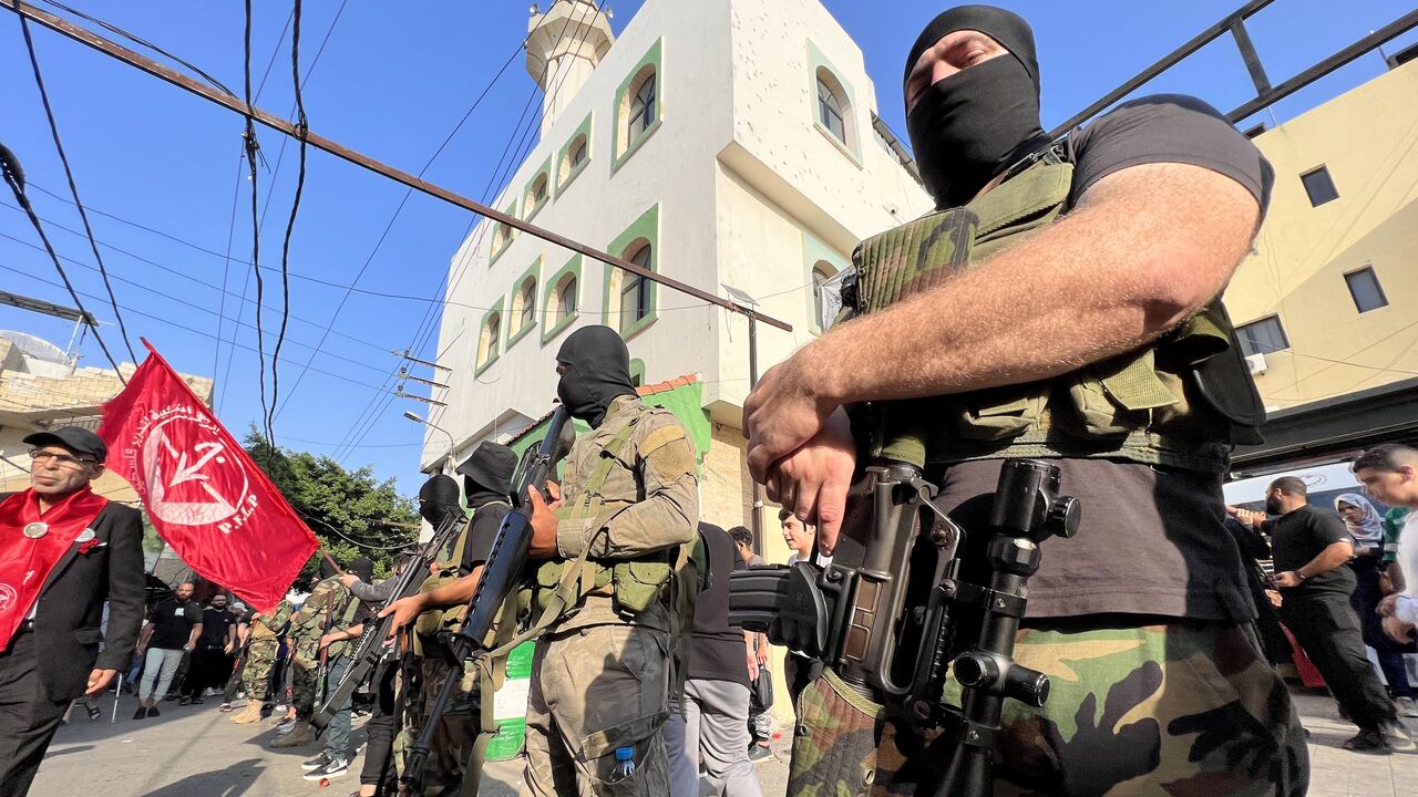 Armed and masked men attend the funeral of two militants from the Popular Front for the Liberation of Palestine in Ain el-Hilweh refugee camp near Sidon on Nov. 1, 2024.