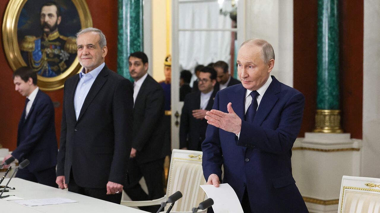In this pool photograph distributed by the Russian state agency Sputnik, Russia's Russian President Vladimir Putin and Iranian President Masoud Pezeshkian arrive for a documents signing ceremony following their talks at the Kremlin in Moscow on January 17, 2025. (Photo by Vyacheslav PROKOFYEV / POOL / AFP) (Photo by VYACHESLAV PROKOFYEV/POOL/AFP via Getty Images)