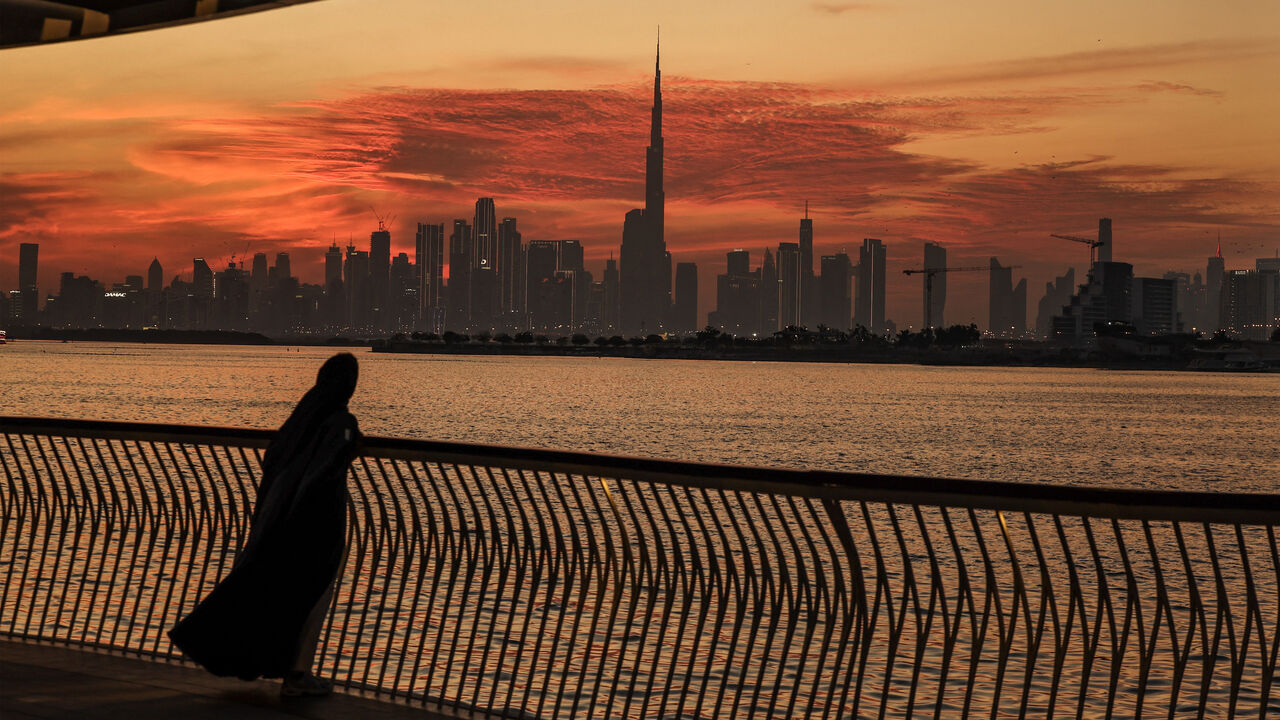 A woman looks on from Creek Harbout at the Dubai skyline with Burj Khalifa, the world's largest building (C) on Feb. 5, 2025.
