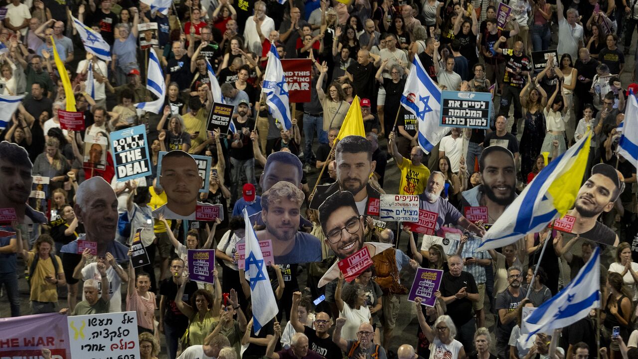 Protesters hold signs and photos of hostages held in the Gaza Strip by Hamas during a rally calling for a hostage deal, May 31, 2025 in Tel Aviv, Israel.