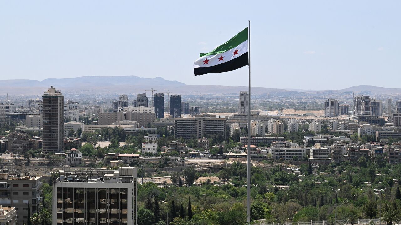A large Syrian flag flutters above Tishreen Park in Damascus, on June 4, 2025.