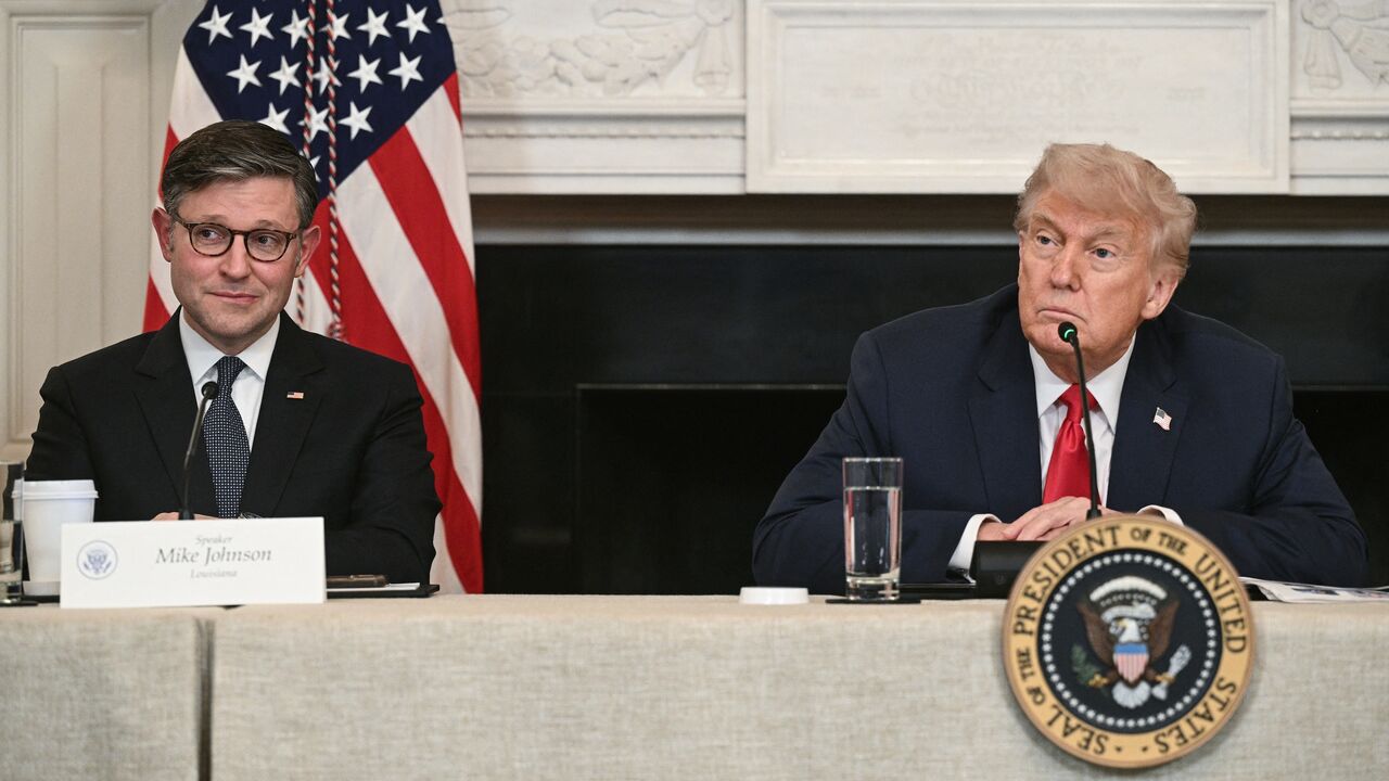 US President Donald Trump, alongside US Speaker of the House Mike Johnson, participates in an "Invest America" roundtable discussion in the State Dining Room of the White House in Washington on June 9, 2025.