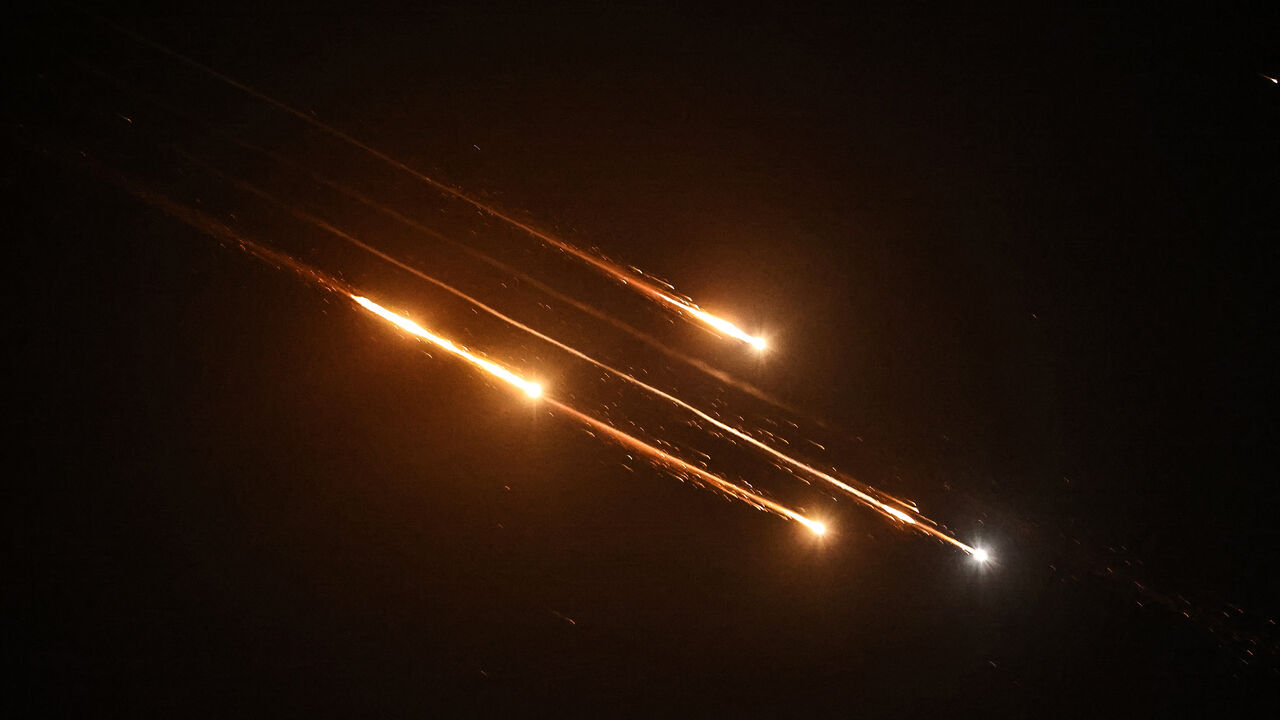 Debris of missiles fired from Iran toward Israel leave trails in the night sky over Nablus in the occupied West bank after being intercepted on June 13, 2025. (Photo by Zain JAAFAR / AFP) (Photo by ZAIN JAAFAR/AFP via Getty Images)