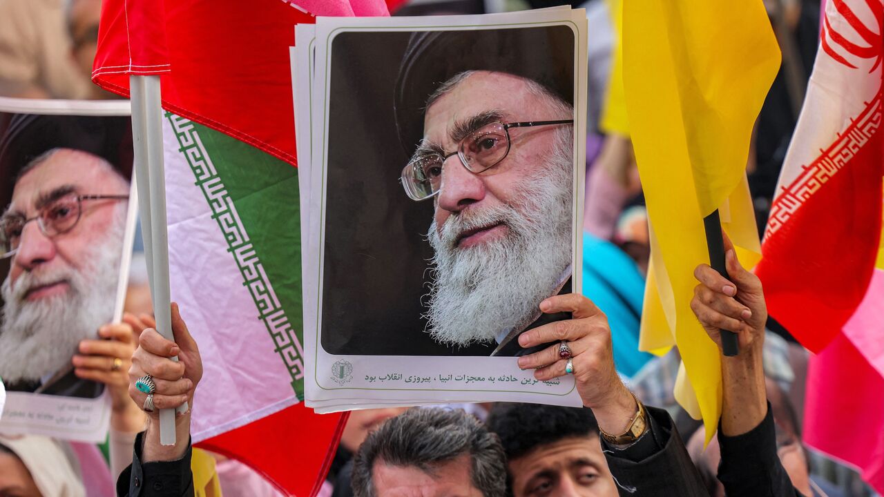 A picture of Iran's supreme leader, Ayatollah Ali Khamenei, is held aloft at a rally on Enghelab (Revolution) Square, Tehran, June 14, 2025.