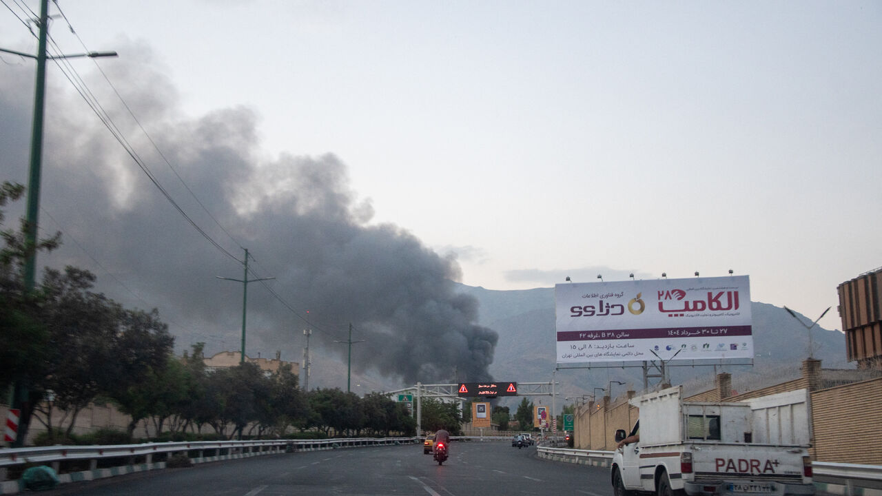 Smoke rises from the rubble of an Iranian state media building in Tehran after an Israeli airstrike on June 16, 2025.
