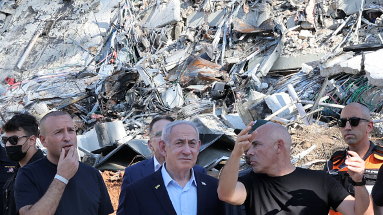 Israel's Prime Minister Benjamin Netanyahu is briefed by Professor Alon Chen, President of the Weizmann Institute of Science, as he visits the facility's site which was hit by an Iranian missile barrage, in the central city of Rehovot on June 20, 2025. (Photo by Jack GUEZ / POOL / AFP) (Photo by JACK GUEZ/POOL/AFP via Getty Images)