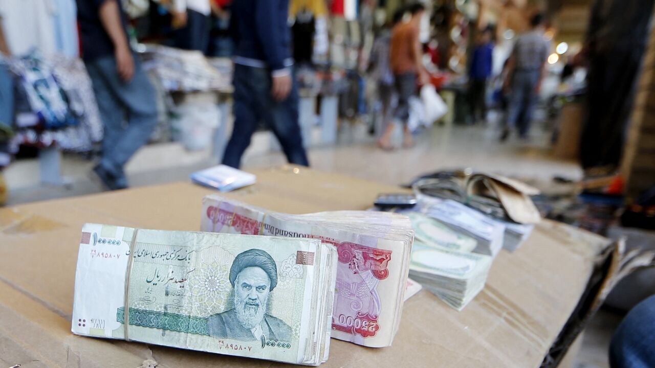 Iranian rial banknotes bearing a portrait of the late founder of the Islamic Republic of Iran, Ayatollah Ruhollah Khomeini, sit on the stand of an Iraqi money dealer on June 19, 2014, in Arbil, Iraq.