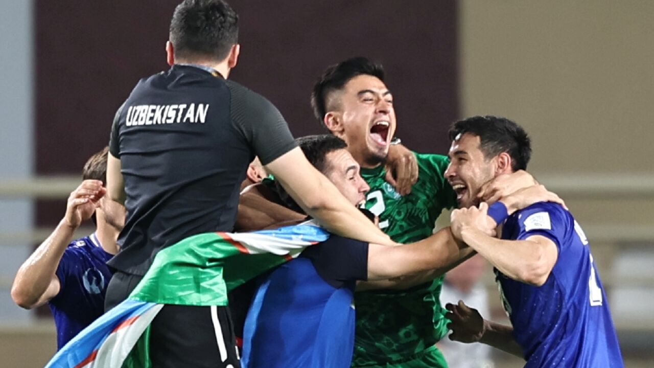 Uzbekistan's players celebrate after qualifying for the World Cup for the first time Uzbekistan's players celebrate after qualifying for the World Cup for the first time