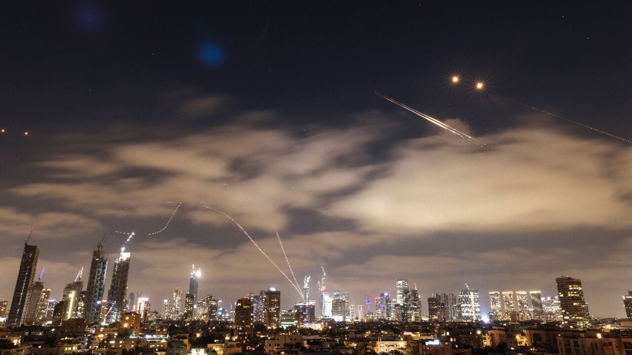 Israeli air defence systems work to intercept Iranian missiles over Tel Aviv on Sunday Israeli air defence systems work to intercept Iranian missiles over Tel Aviv on Sunday