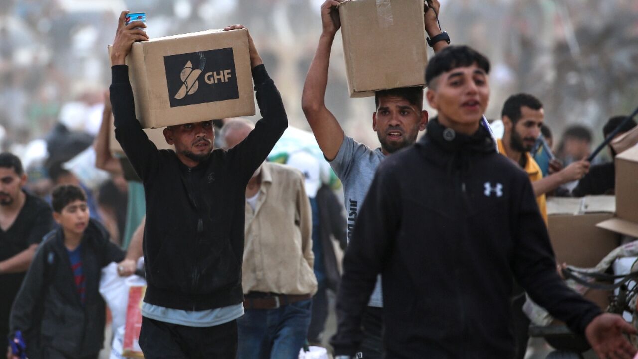 People carry supplies from a Gaza Humanitarian Foundation distribution centre in the central Gaza Strip People carry supplies from a Gaza Humanitarian Foundation distribution centre in the central Gaza Strip