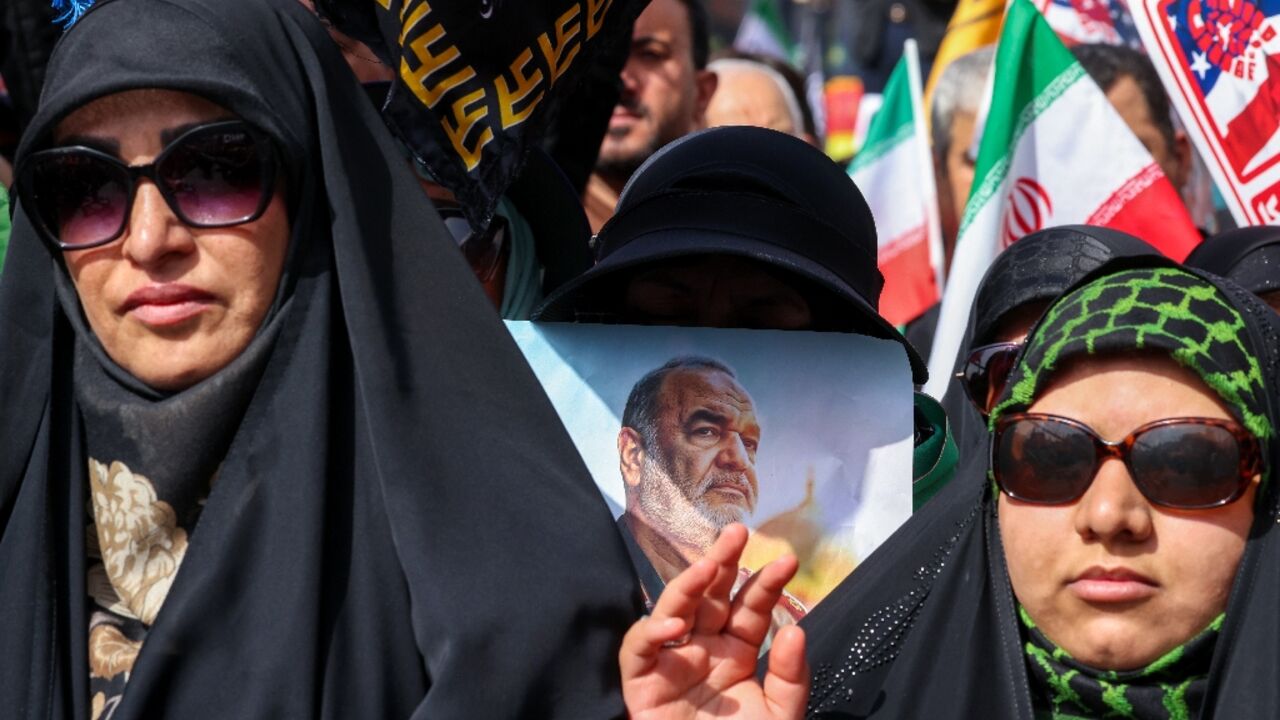 A woman holds a portrait of slain Iranian Revolutionary Guards commander Hossein Salami as mourners attend his funeral and that of other military commanders killed during Israeli strikes A woman holds a portrait of slain Iranian Revolutionary Guards commander Hossein Salami as mourners attend his funeral and that of other military commanders killed during Israeli strikes