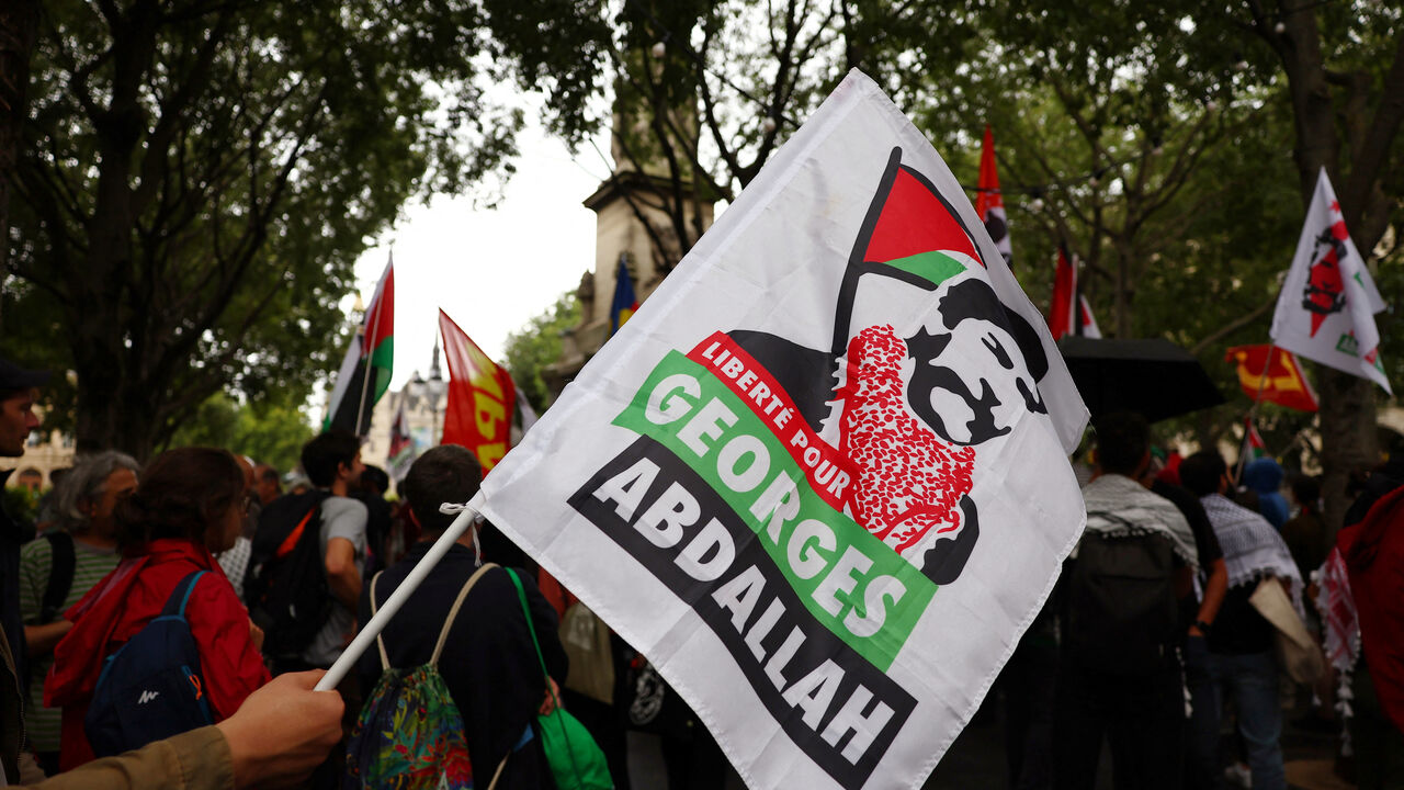 FILE PHOTO: A protester holds a flag with the slogan "Freedom for Georges Abdallah" during a demonstration to demand the immediate and unconditional release of Georges Ibrahim Abdallah, a Lebanese militant held in France since 1984, on the eve of a French appeals court ruling on his conditional release, in Paris, France, July 16, 2025.  REUTERS/Abdul Saboor/File photo
