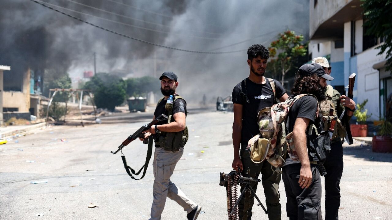 A thick pall of smoke rises over the Syrian city of Sweida as armed Bedouin and their allies battle Druze fighters on the streets despite a ceasefire order from the president's office. A thick pall of smoke rises over the Syrian city of Sweida as armed Bedouin and their allies battle Druze fighters on the streets despite a ceasefire order from the president's office.