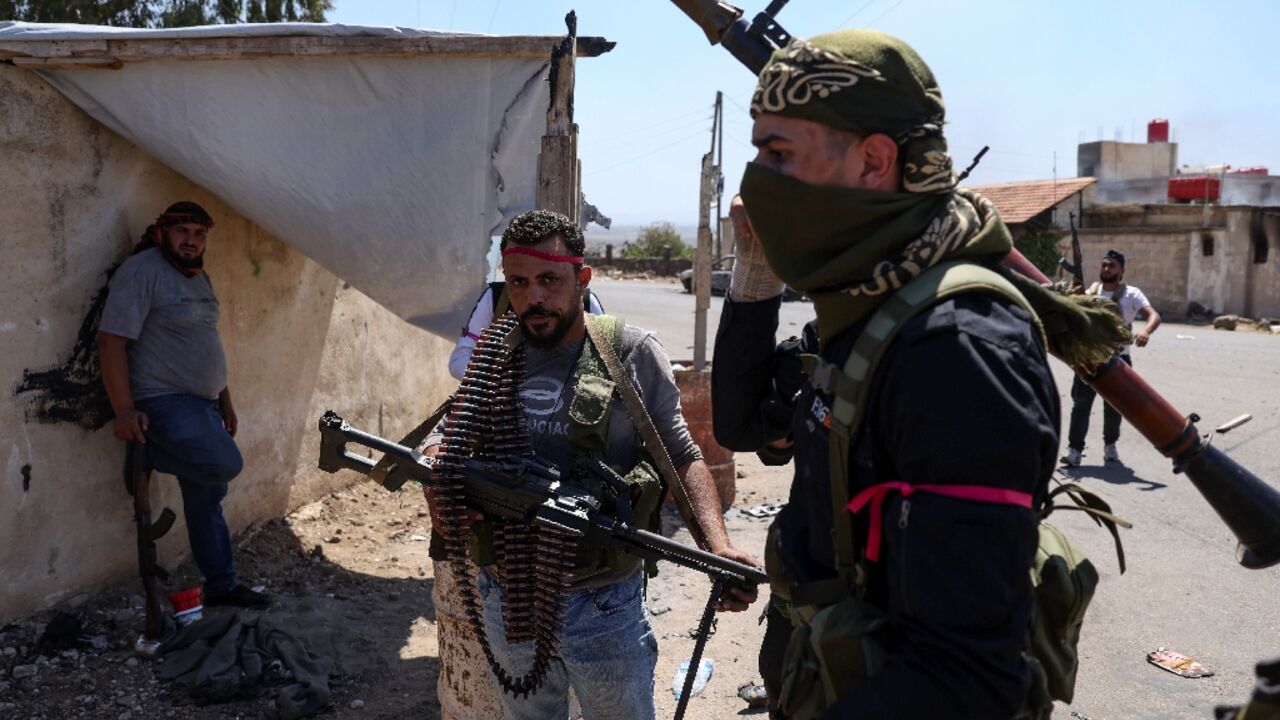 Armed Bedouin gather in the village of Al-Mazraa outside Sweida as clashes flare with Druze fighters, a day after the Syrian army withdrew from the province, heartland of the Druze minority. Armed Bedouin gather in the village of Al-Mazraa outside Sweida as clashes flare with Druze fighters, a day after the Syrian army withdrew from the province, heartland of the Druze minority.