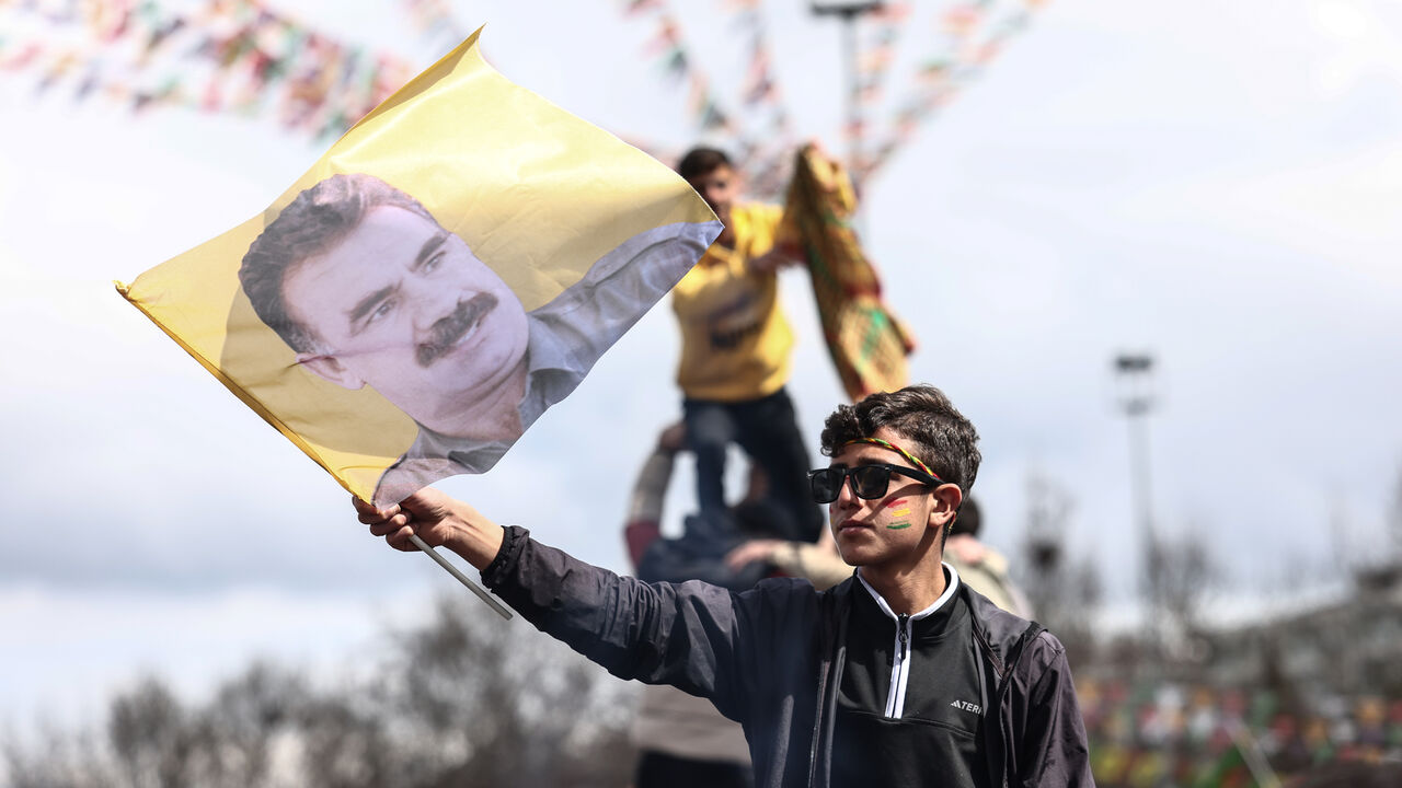 Kurdish youths holds a poster of jailed PKK militant group leader Abdullah Ocalan during Newroz celebrations, Diyarbakir, Turkey, March 21, 2025.