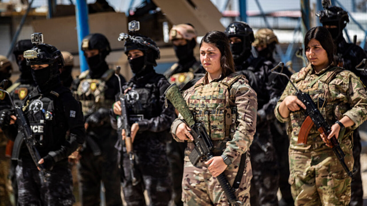 Members of the Syrian Kurdish Asayish security forces stand guard at the Kurdish-run al-Hol camp in the northeastern Hasakeh governorate, on April 18, 2025. (DELIL SOULEIMAN/AFP via Getty Images)