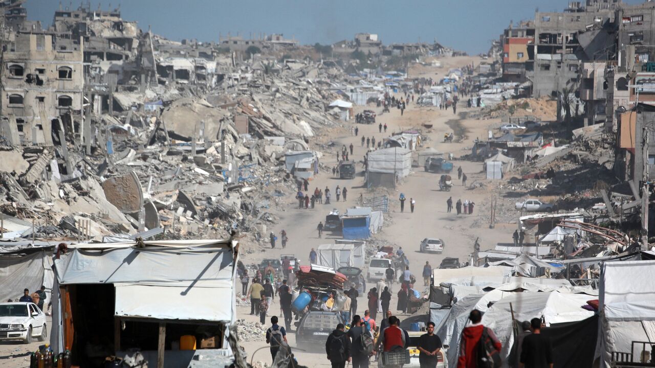 Palestinians carry their belongings as they flee Gaza City, May 16, 2025.