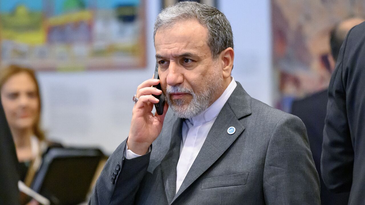 Iranian Foreign Minister Abbas Araghchi talks on his mobile phone ahead the family photo during the 51st session of the Council of Foreign Ministers of the Organization of Islamic Cooperation (OIC) in Istanbul, on June 21, 2025. 