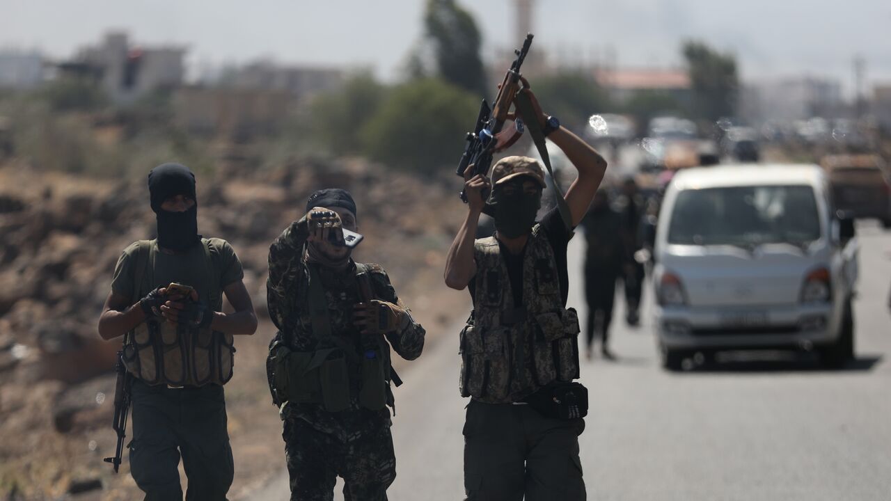 Bedouin fighters are seen on the streets of al-Mazraa village in Syria's southern Suwayda governorate on July 18, 2025, in Suwayda, Syria. 
