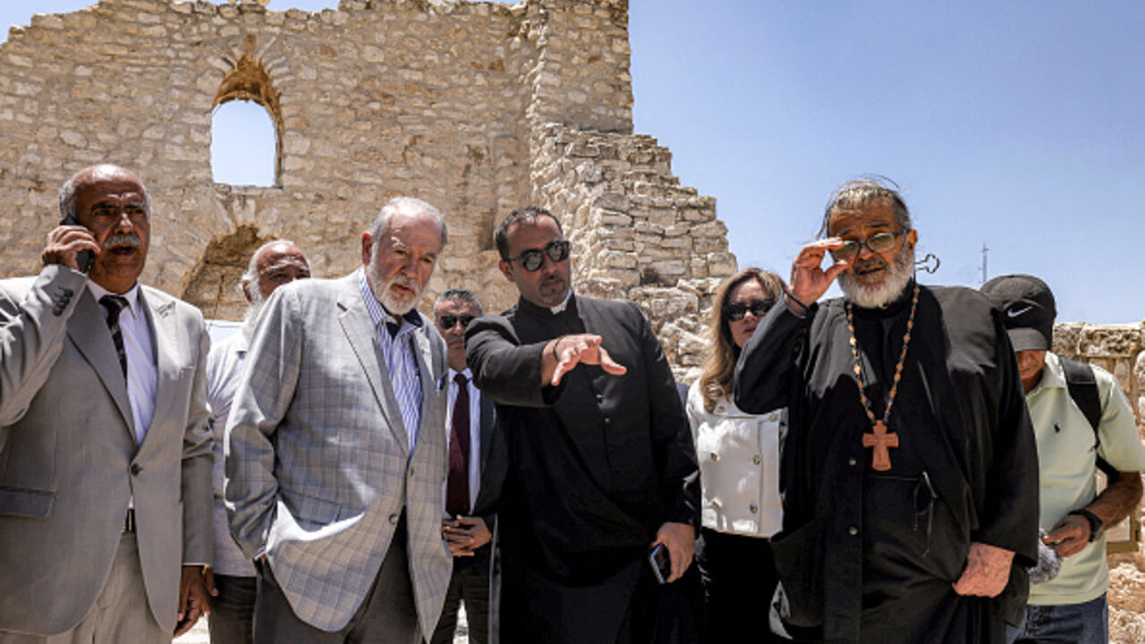 US ambassador to Israel Mike Huckabee (2nd-L) and the Palestinian mayor of the village of Taybeh, Suleiman Khourieh (L), tour the fifth-century Church of St George in the Palestinian Christian village of Taybeh in the occupied West Bank, on July 19, 2025.