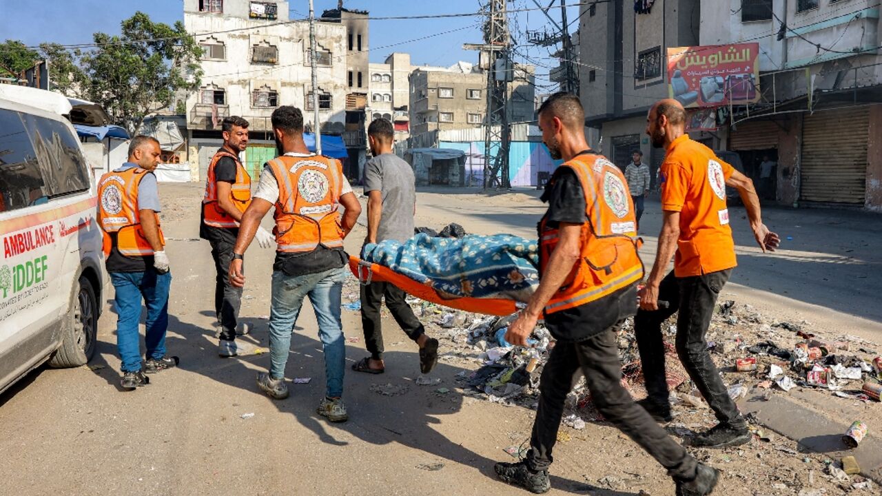 Palestinian rescuers carried a victim of an Israeli strike in Gaza City Palestinian rescuers carried a victim of an Israeli strike in Gaza City