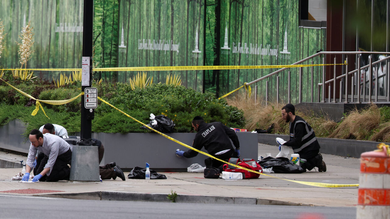 FILE PHOTO: Members of the group Misaskim clean blood off the ground where two Israeli embassy staff were shot dead near the Capital Jewish Museum in Washington, D.C., U.S. May 22, 2025.  REUTERS/Evelyn Hockstein/File Photo