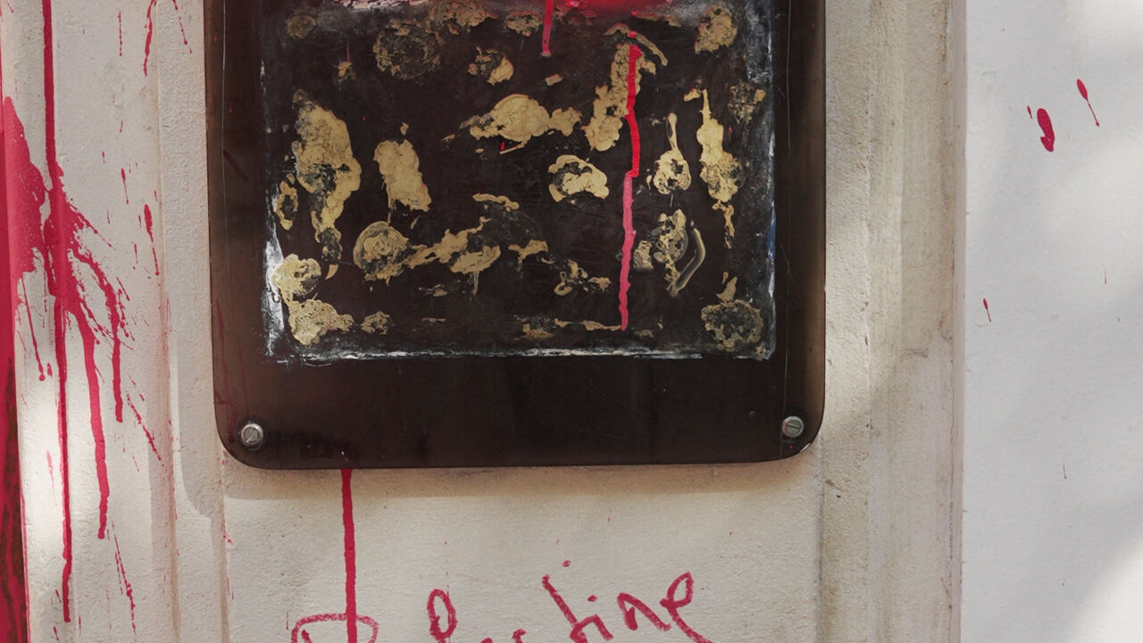 A view of slogans 'EL AL genocide airline' and 'Palestine will live and will win', sprayed with red paint on the entrance of the EL AL Israel Airlines offices in Paris, France August 7, 2025. REUTERS/Noemie Olive