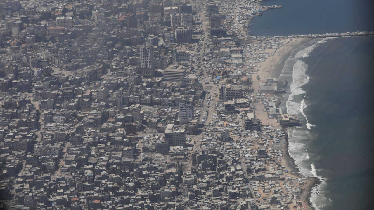 FILE PHOTO: An aerial view from a Jordanian military aircraft shows the Gaza Strip, before humanitarian aid is airdropped over it, in Gaza, August 17, 2025. REUTERS/Alaa Al Sukhni/File Photo