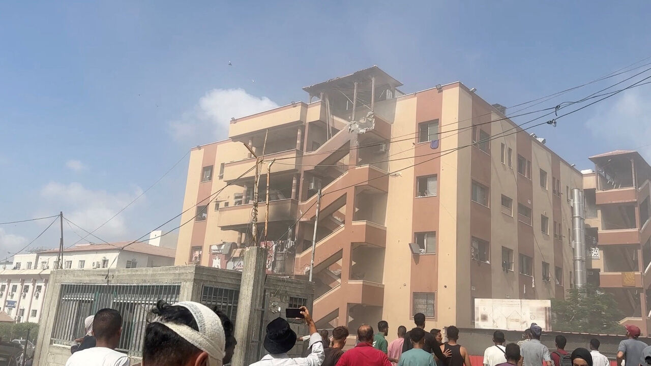 FILE PHOTO: People walk at the site of Israeli strikes on Nasser hospital where Palestinian cameraman Hussam al-Masri, who was a contractor for Reuters, was killed along with other journalists and people, in Khan Younis in the southern Gaza Strip in this still image taken from video, August 25, 2025. REUTERS/Hatem Khaled/ File Photo