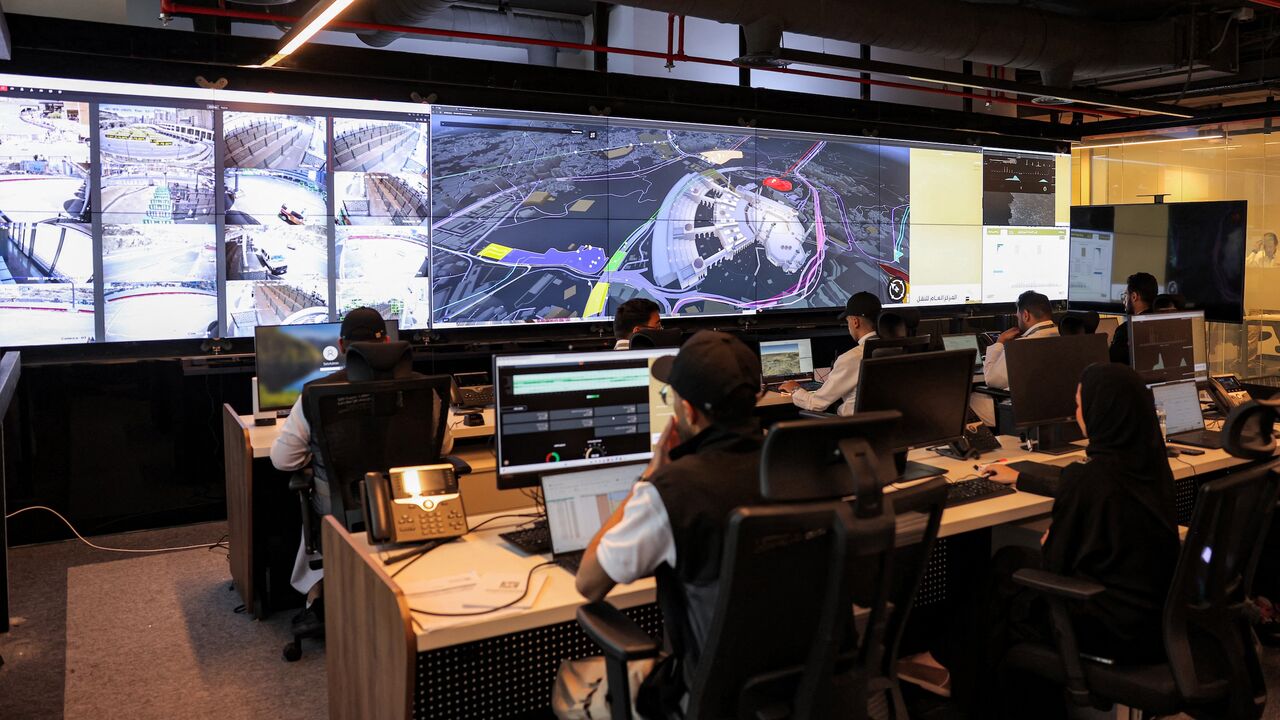 Employees man their terminals at the control room for traffic and crowd management for pilgrims at the General Transport Centre at the Royal Commission for Mecca and Holy Sites in Mecca on June 3, 2025.