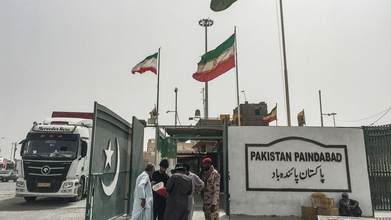 Pakistani security personnel check the documents of people who came from Iran at the Pakistan-Iran border in Taftan on June 16, 2025.