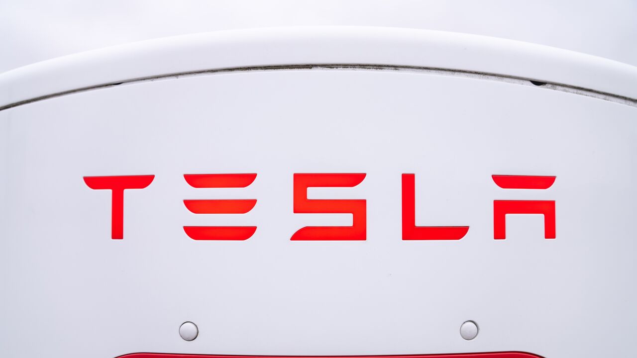 The logo of a Tesla electric vehicle charging station in a parking lot on March 20, 2025, in Hamilton, Canada.