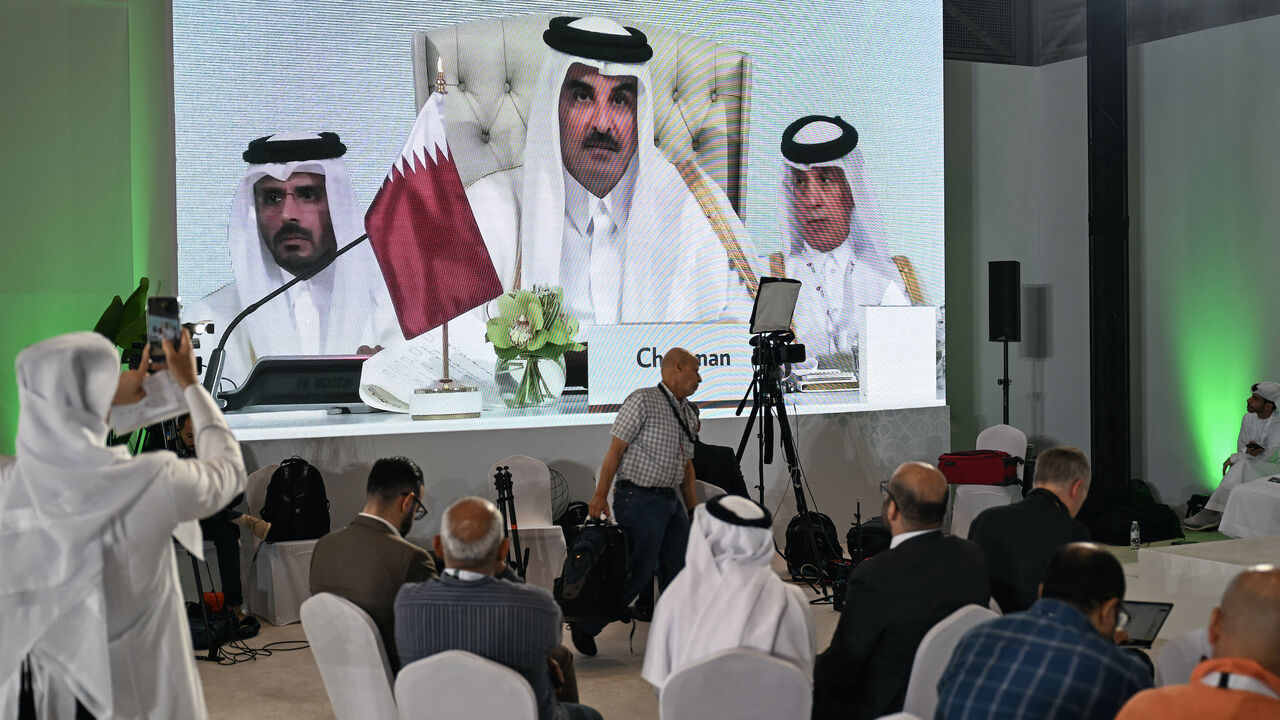 Reporters follow Qatar's Emir Sheikh Tamim bin Hamad Al-Thani's address at the media centre, during the opening of the 2025 Arab-Islamic emergency summit in Doha on Sept. 15, 2025.