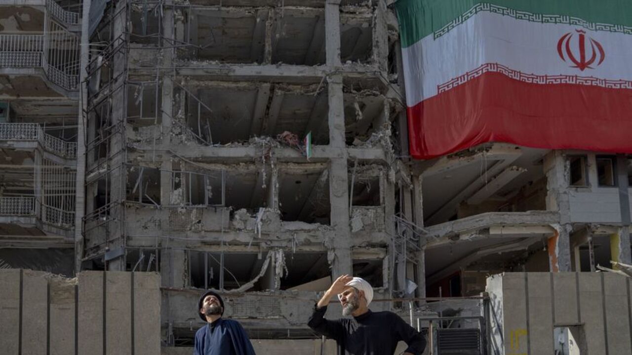 Two men look at houses destroyed in Israeli attacks, July 12, 2025, Tehran. (Majid Saeedi/Getty Images)