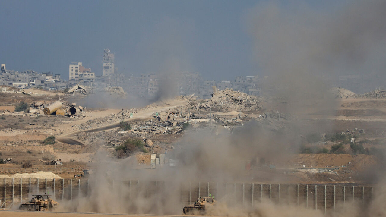 An Israeli military vehicles manoeuvre on the Israeli side of the Israel-Gaza border, as seen from southern Israel, October 7, 2025. REUTERS/Ronen Zvulun
