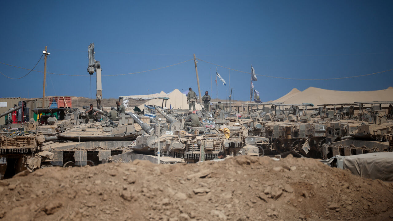 Israeli soldiers on military vehicles near the Israel-Gaza border, after a ceasefire between Israel and Hamas in Gaza went into effect, in Israel, October 10, 2025. REUTERS/Shir Torem