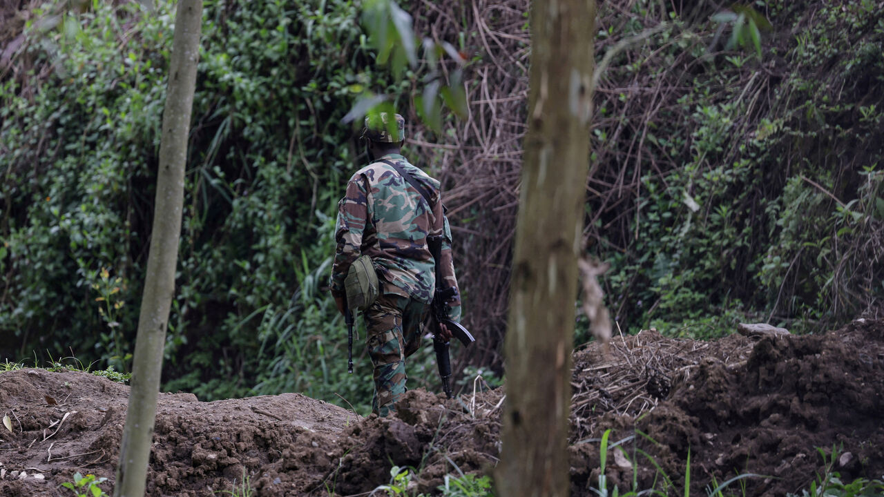 FILE PHOTO: An M23 rebel walks on the outskirts of Matanda which is controlled by M23 rebels, in eastern Democratic Republic of Congo, March 22, 2025. REUTERS/Zohra Bensemra/File Photo