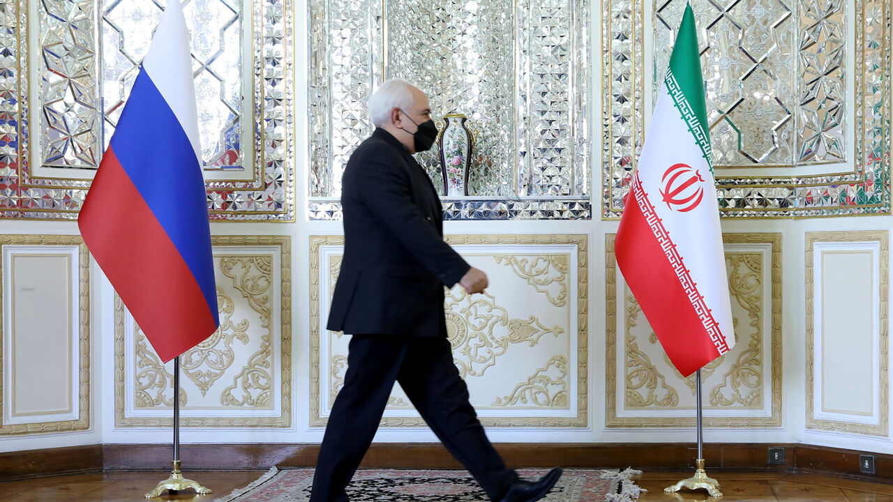 Iran's Foreign Minister Mohammad Javad Zarif passes by the Iranian and Russian flags before meeting with Russia's Foreign Minister Sergei Lavrov in Tehran, Iran April 13, 2021. Iran's Foreign Ministry/WANA (West Asia News Agency)/Handout via REUTERS