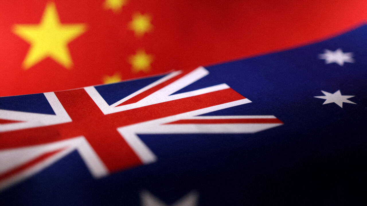 Printed Chinese and Australian flags are seen in this illustration, July 21, 2022. REUTERS/Dado Ruvic/Illustration