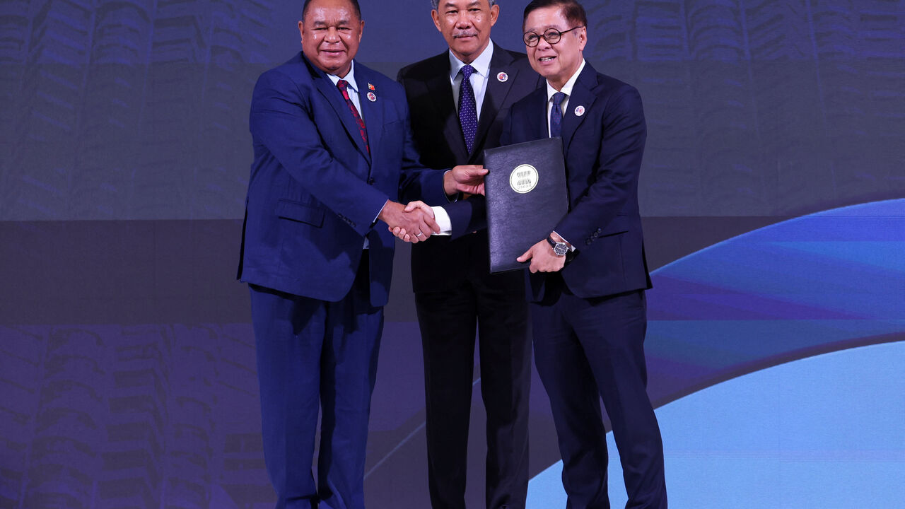 Timor-Leste's Foreign Minister Bendito Freitas, Malaysia's Foreign Minister Mohamad Hasan and Thailand's Foreign Minister Sihasak Phuangketkeow attend a ceremony for the accession of Timor-Leste to the ASEAN charter in Kuala Lumpur, Malaysia October 25, 2025. REUTERS/Chalinee Thirasupa