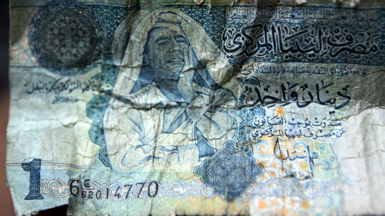 Picture of a Libyan dinar banknote bearing a portrait of former leader Moammar Gadhafi is pictured in Tripoli, on Sept. 8, 2011.