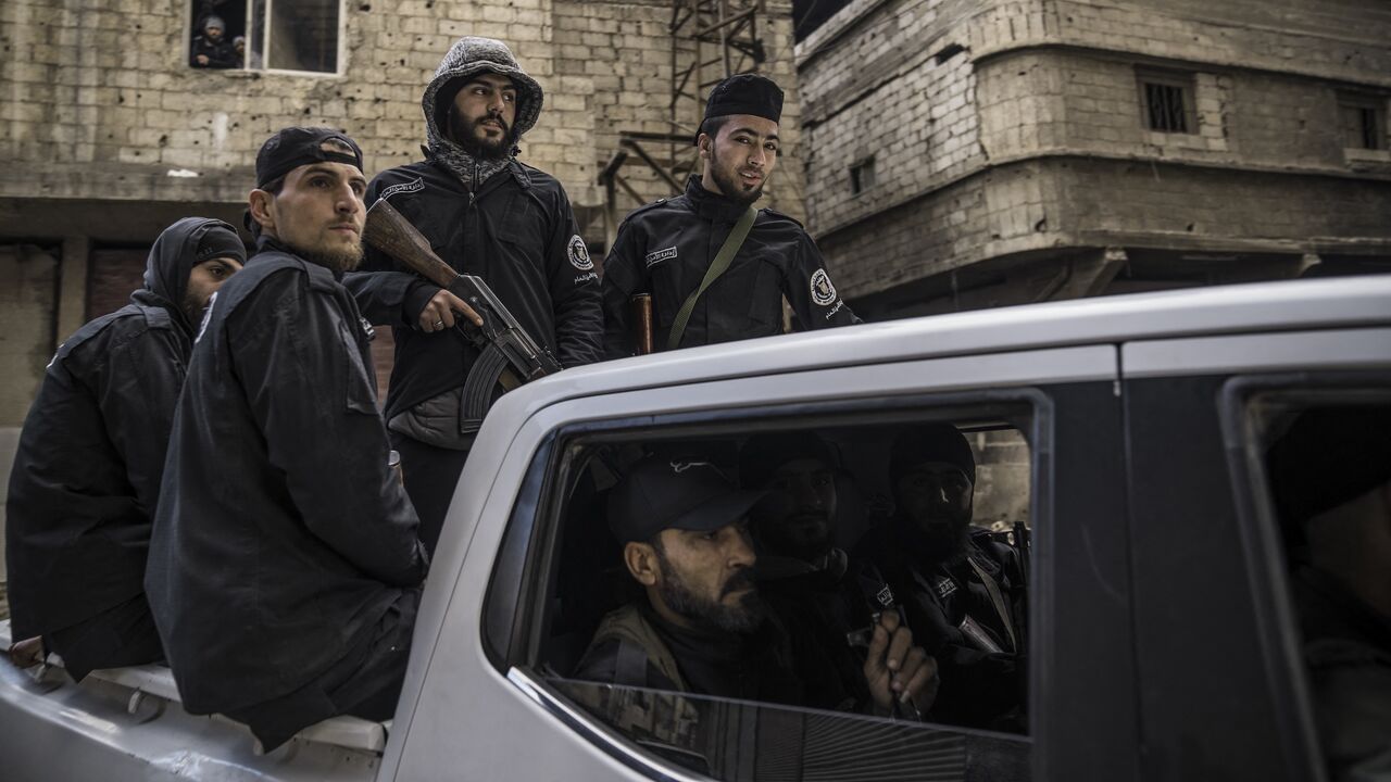 Syria's internal security forces are deployed in Tadamon to secure a protest in Tadamon, Syria, on Feb. 7, 2025.