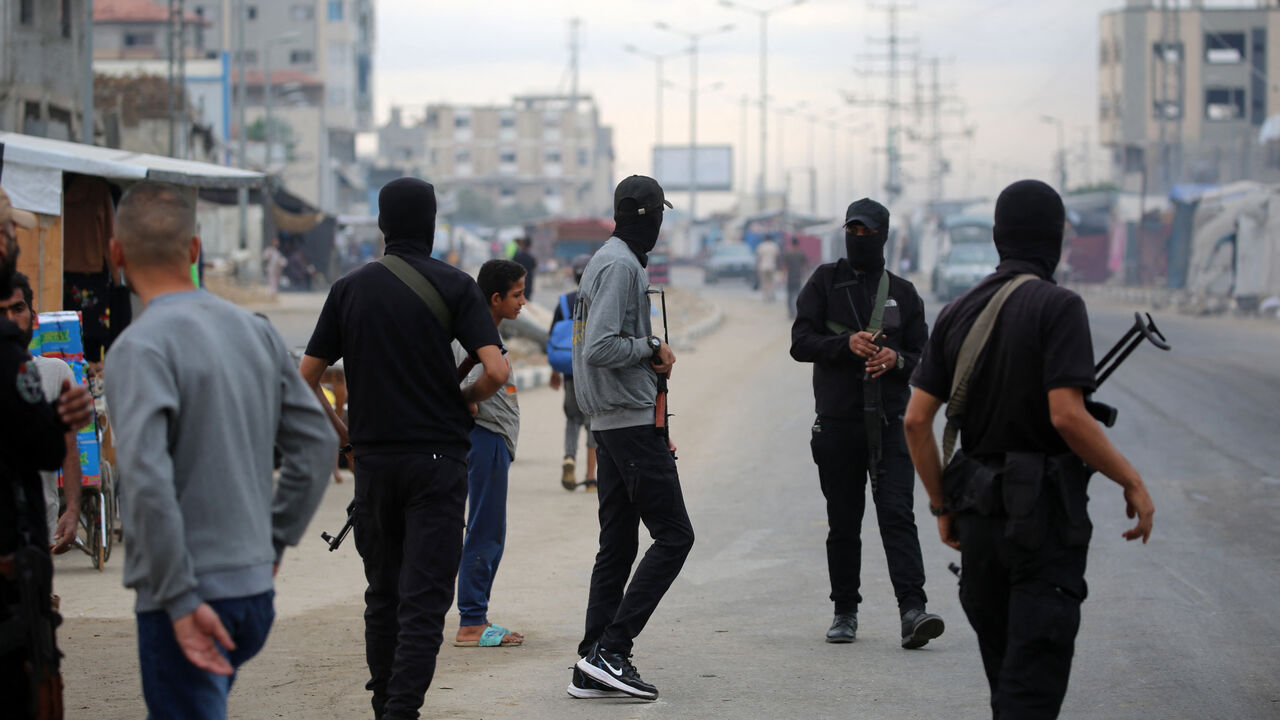 Members of the internal security forces loyal to the Palestinian group Hamas, man a checkpoint in the Nuseirat refugee camp in the central Gaza Strip, on Oct. 12, 2025.