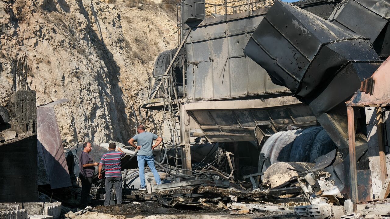 Men inspect the wreckage of a damaged cement factory following overnight Israeli airstrikes in Ansar, southern Lebanon, on Oct. 17, 2025.