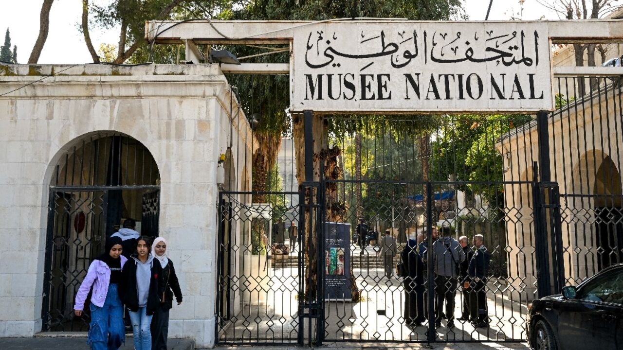 (FILES) Youngsters walk outside Syria's National Museum as it reopens to visitors, in Damascus