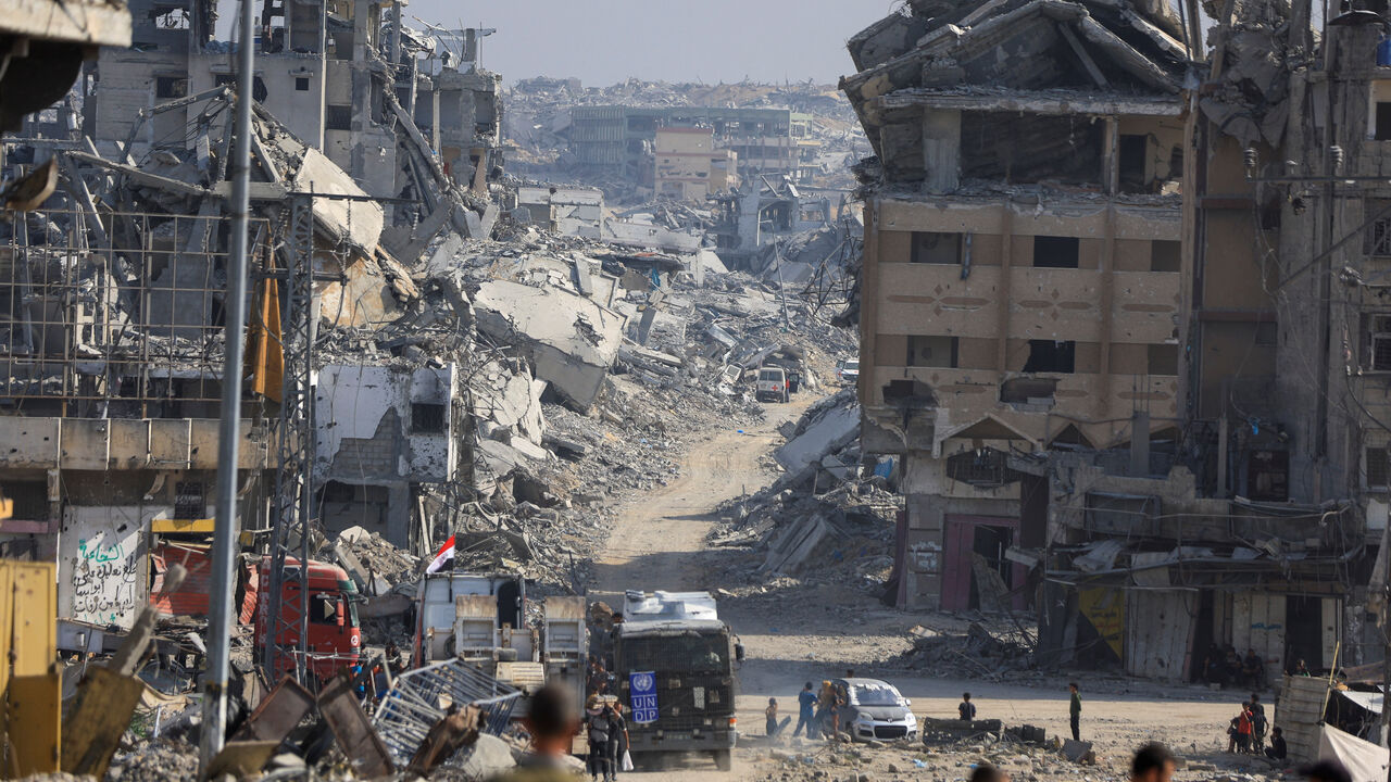 Palestinians gather as Red Cross personnel work in an area within the so-called "yellow line" to which Israeli troops withdrew under the ceasefire, as Hamas says it continues to search for the bodies of deceased hostages seized during the October 7, 2023, attack on Israel, in Gaza City November 2, 2025. REUTERS/Dawoud Abu Alkas